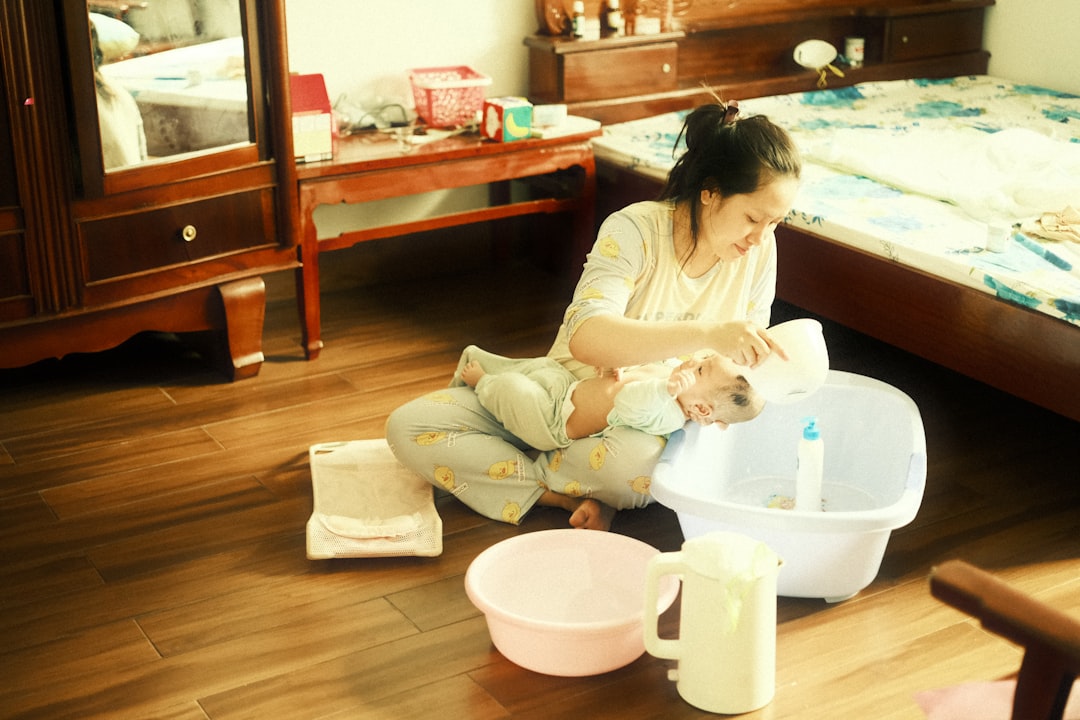 a-young-girl-sitting-on-the-floor-playing-with-a-cat-d5d4o1at5m8